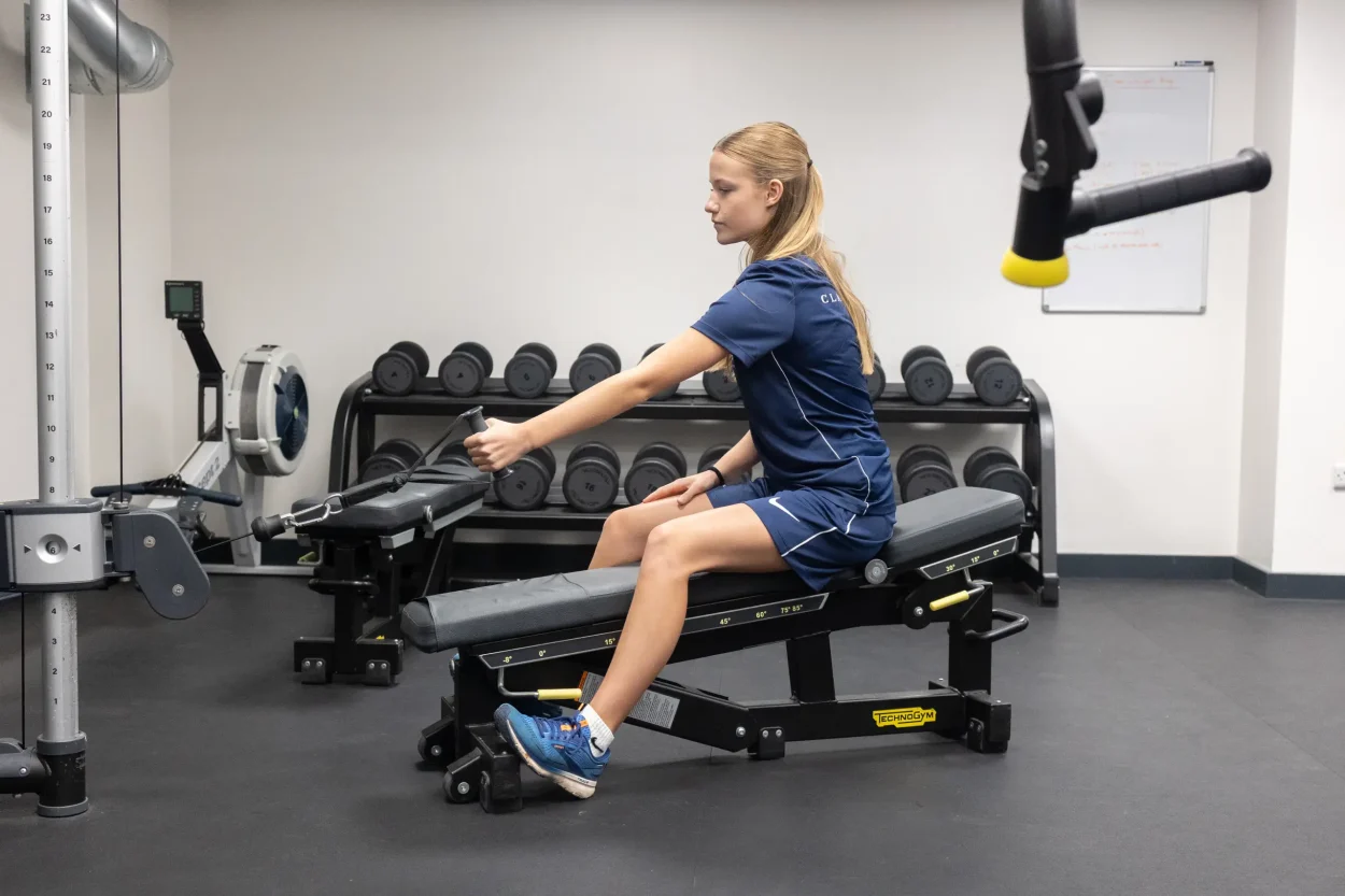 A female Clayesmore academy student completing strength and conditioning training
