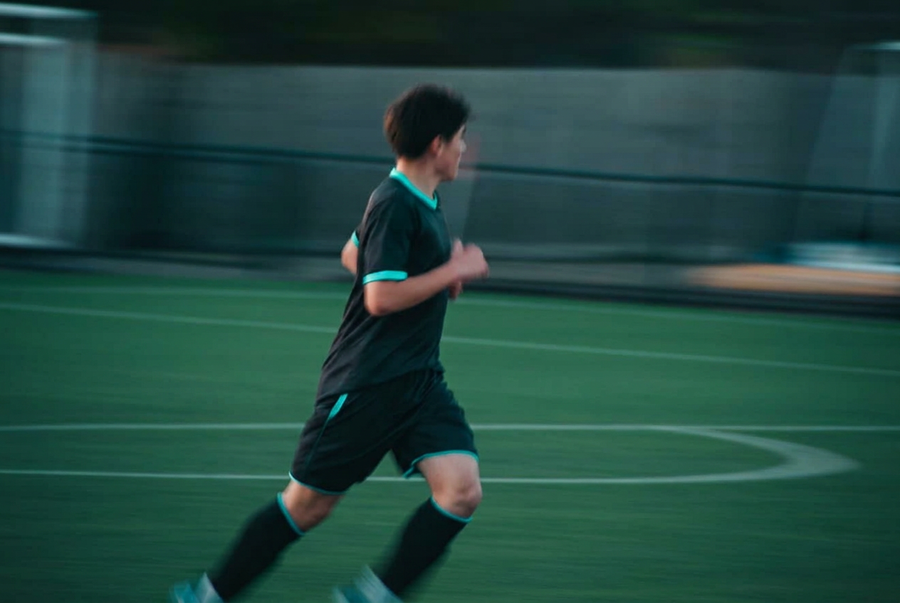 Stride USA athlete sprinting under floodlights