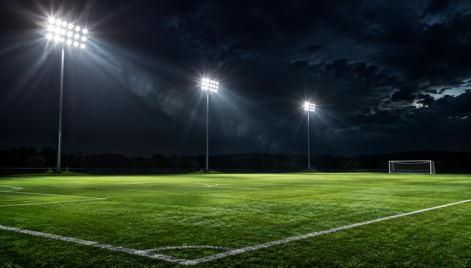 Floodlights over a soccer pitch at night