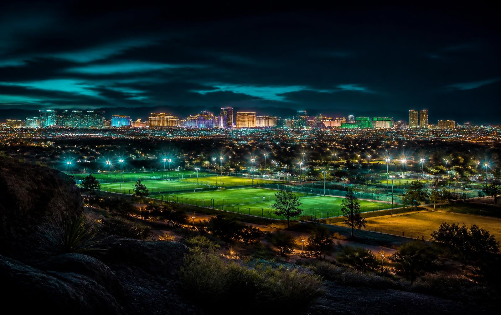 Floodlit pitches with the Las Vegas skyline behind